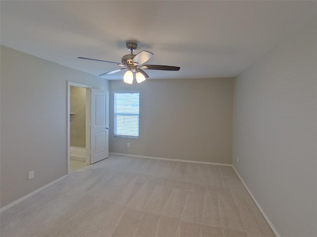 116 Cornstalk Lane Princeton, TX 75407 - Photo 6 of 17 an empty room with a chandelier fan and windows