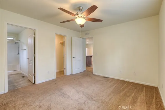 an empty room with fan and a ceiling fan