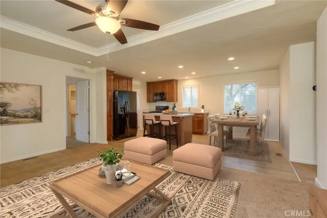 a living room with furniture and kitchen view