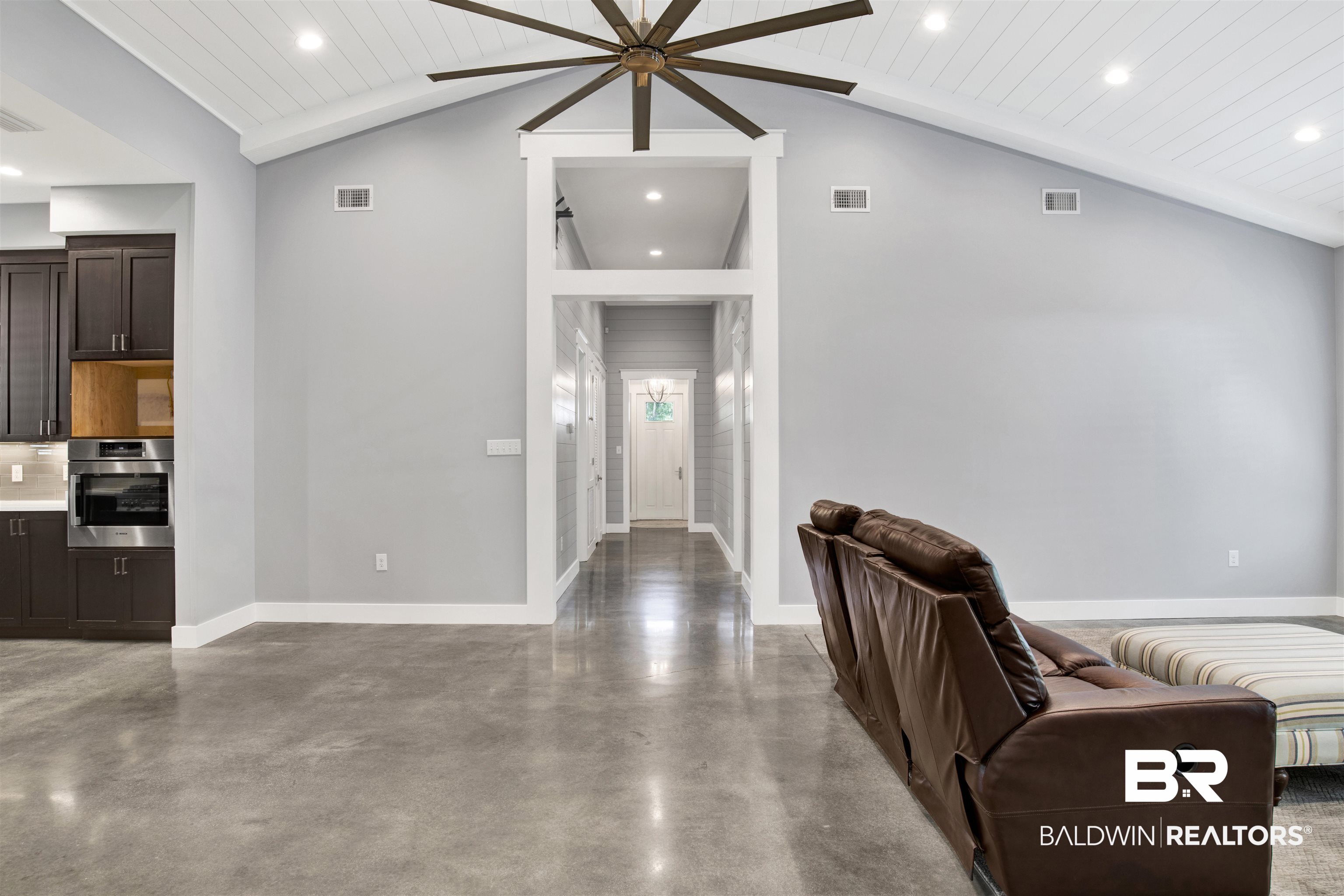 27980 Canal Road Orange Beach, AL 36561 - Photo 25 of 46 Living area with finished concrete floors, recessed lighting, vaulted ceiling, ceiling fan, and wooden ceiling