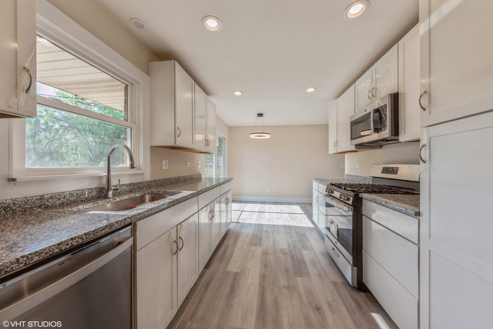 108 Roberts Road New Lenox, IL 60451 - Photo 5 of 16 a kitchen with stainless steel appliances granite countertop a sink a stove and a wooden floors