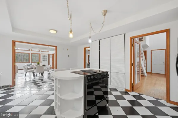 a view of a dining room with furniture large windows and wooden floor