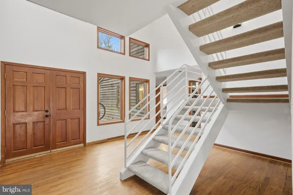 a view of an entryway with wooden floor