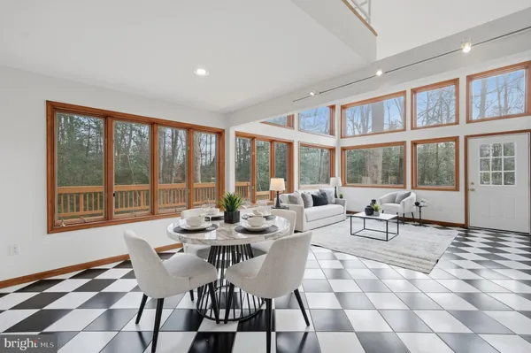 a living room with furniture and floor to ceiling window