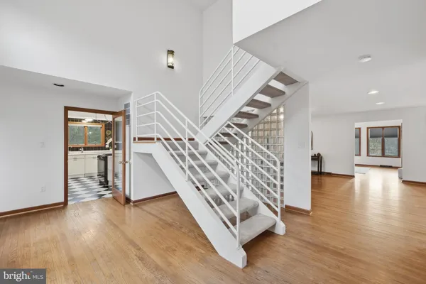a view of entryway and hall with wooden floor