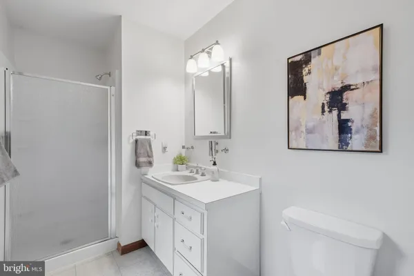a bathroom with a sink vanity and a mirror