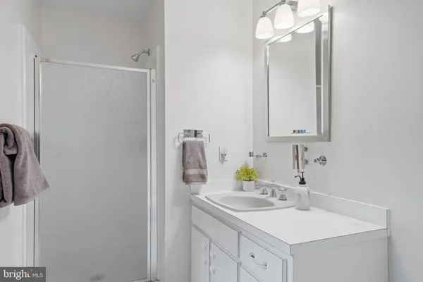 a kitchen with stainless steel appliances granite countertop a sink a stove a refrigerator and a dining table with the view