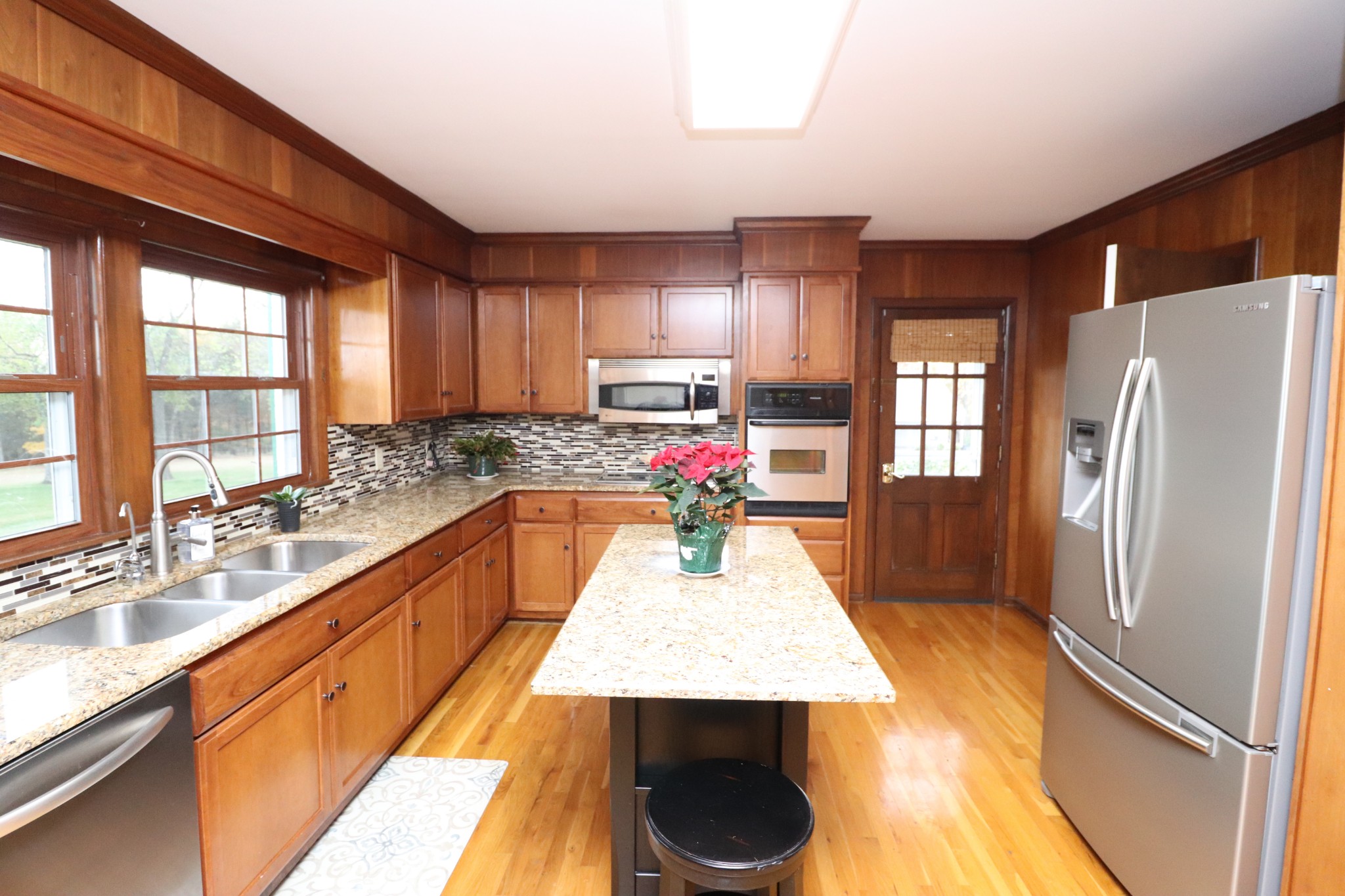 545 Puryears Bend Road Hartsville, TN 37074 - Photo 12 of 50 a large kitchen with kitchen island a large counter space wooden floor and stainless steel appliances