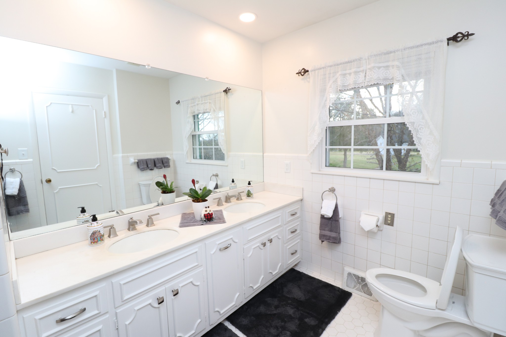 545 Puryears Bend Road Hartsville, TN 37074 - Photo 21 of 50 a bathroom with a double vanity sink toilet and a mirror