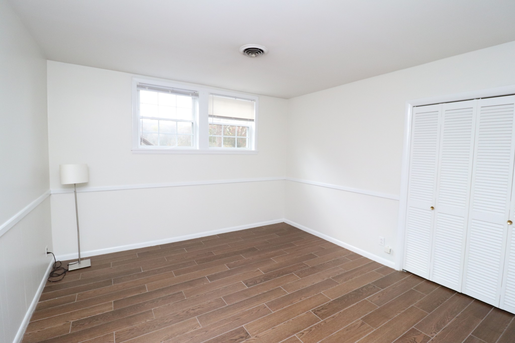 545 Puryears Bend Road Hartsville, TN 37074 - Photo 27 of 50 an empty room with wooden floor and windows