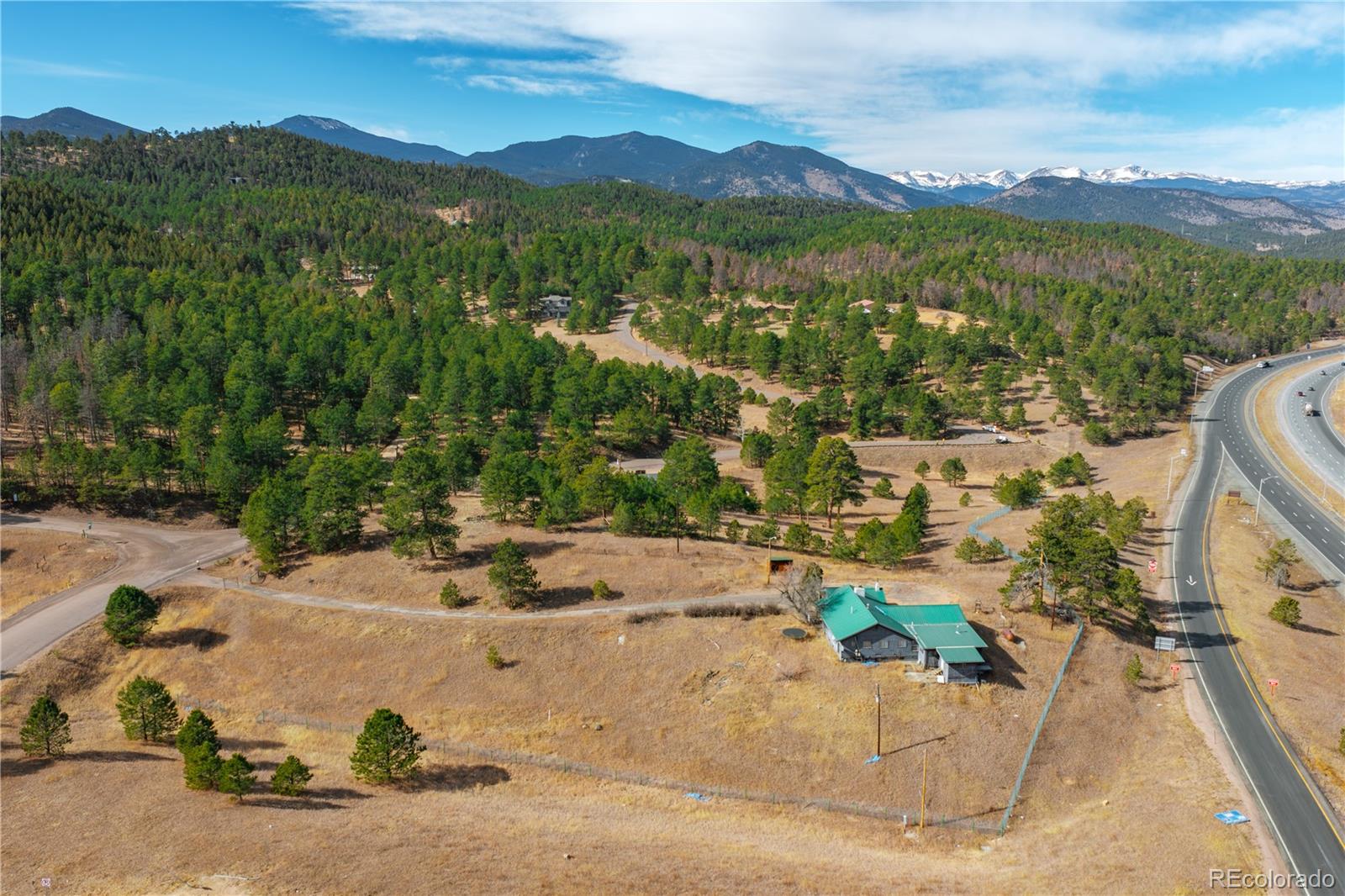 29793 Ruby Ranch Road Evergreen, CO 80439 - Photo 12 of 39 an aerial view of a house with a garden and lake view