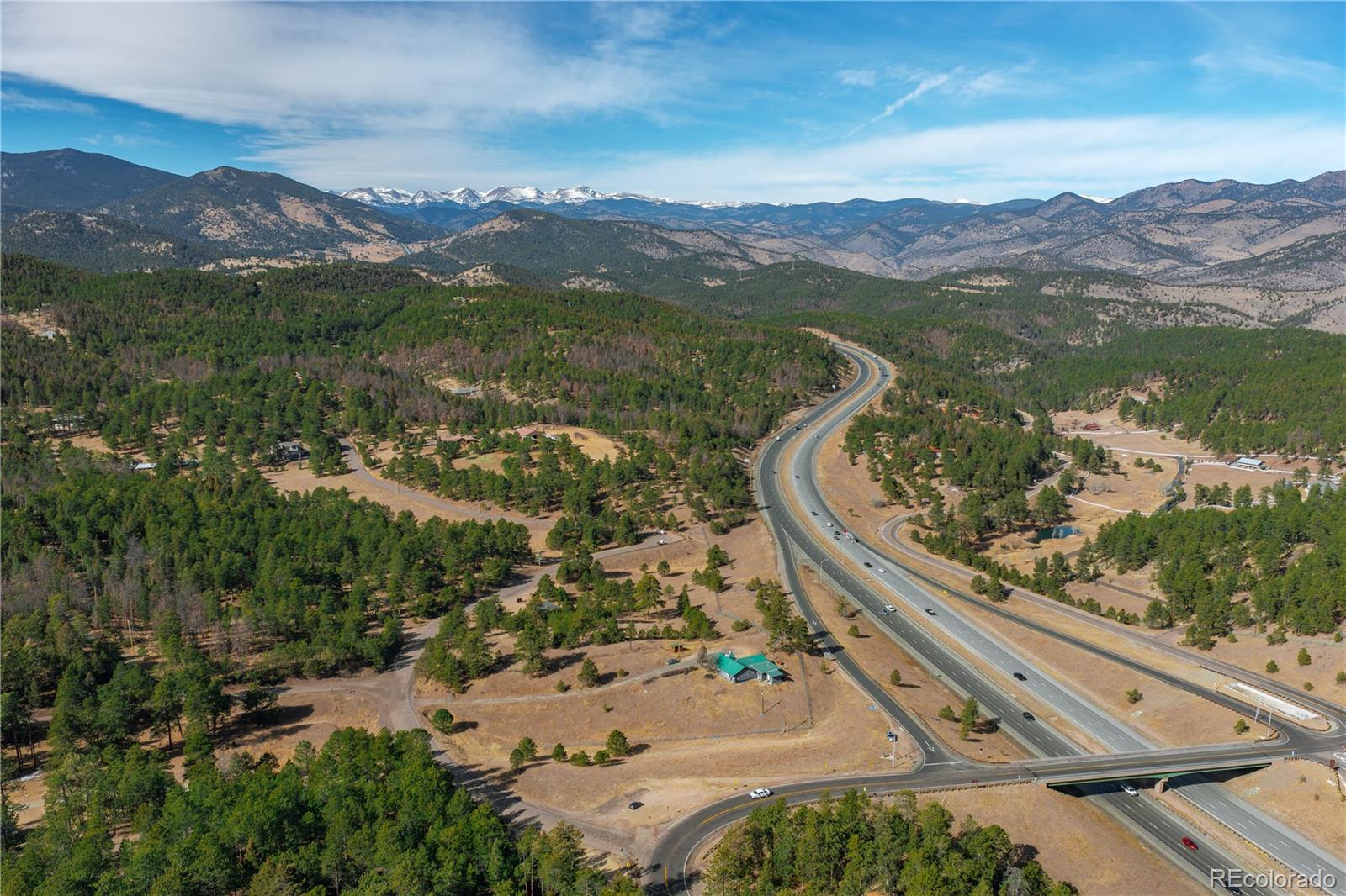 29793 Ruby Ranch Road Evergreen, CO 80439 - Photo 2 of 39 a view of a city with mountains in the background
