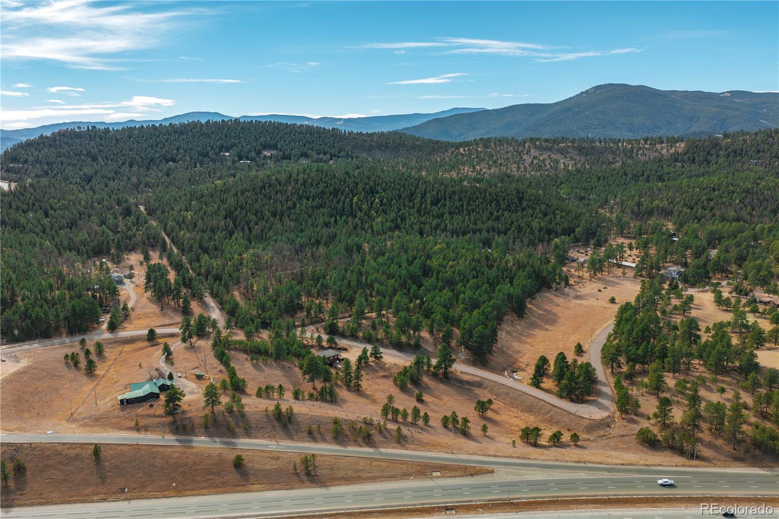 29793 Ruby Ranch Road Evergreen, CO 80439 - Photo 23 of 39 a view of a town with floor to ceiling window