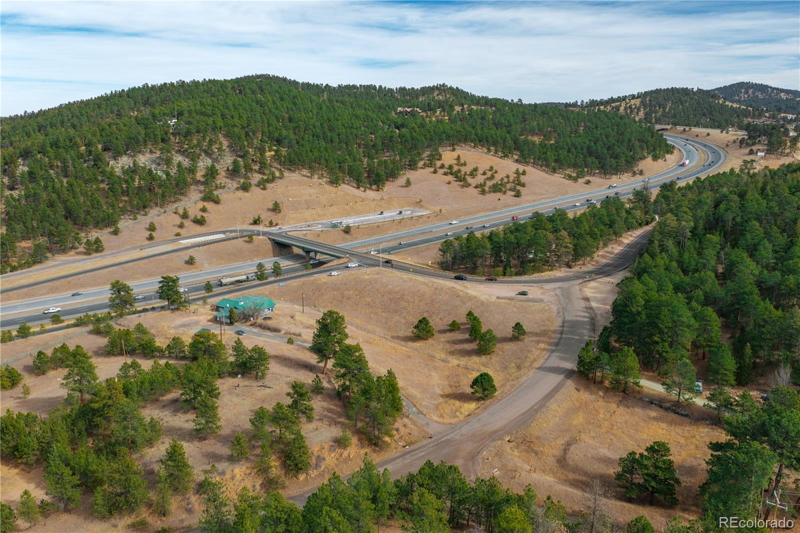29793 Ruby Ranch Road Evergreen, CO 80439 - Photo 27 of 39 an aerial view of residential houses with outdoor space and trees all around
