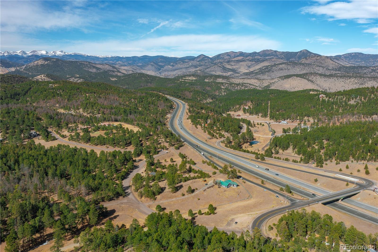 29793 Ruby Ranch Road Evergreen, CO 80439 - Photo 3 of 39 a view of a city with mountains in the background