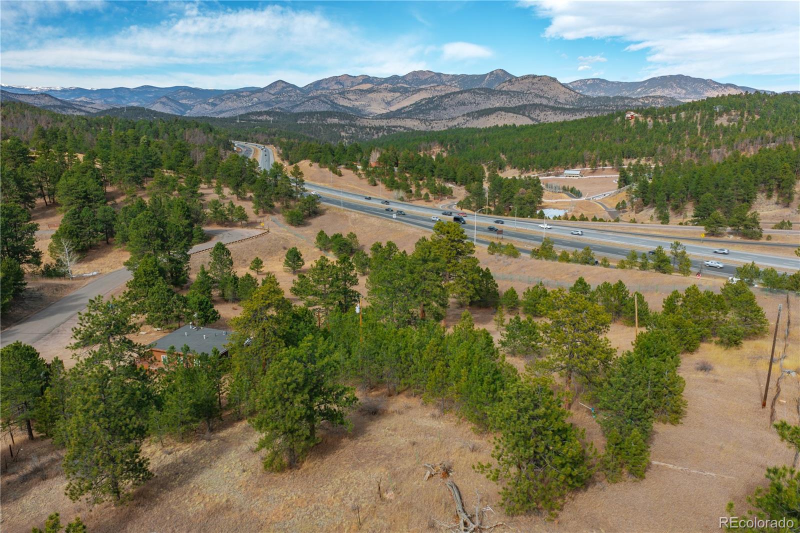 29793 Ruby Ranch Road Evergreen, CO 80439 - Photo 31 of 39 a view of a mountain with a lake