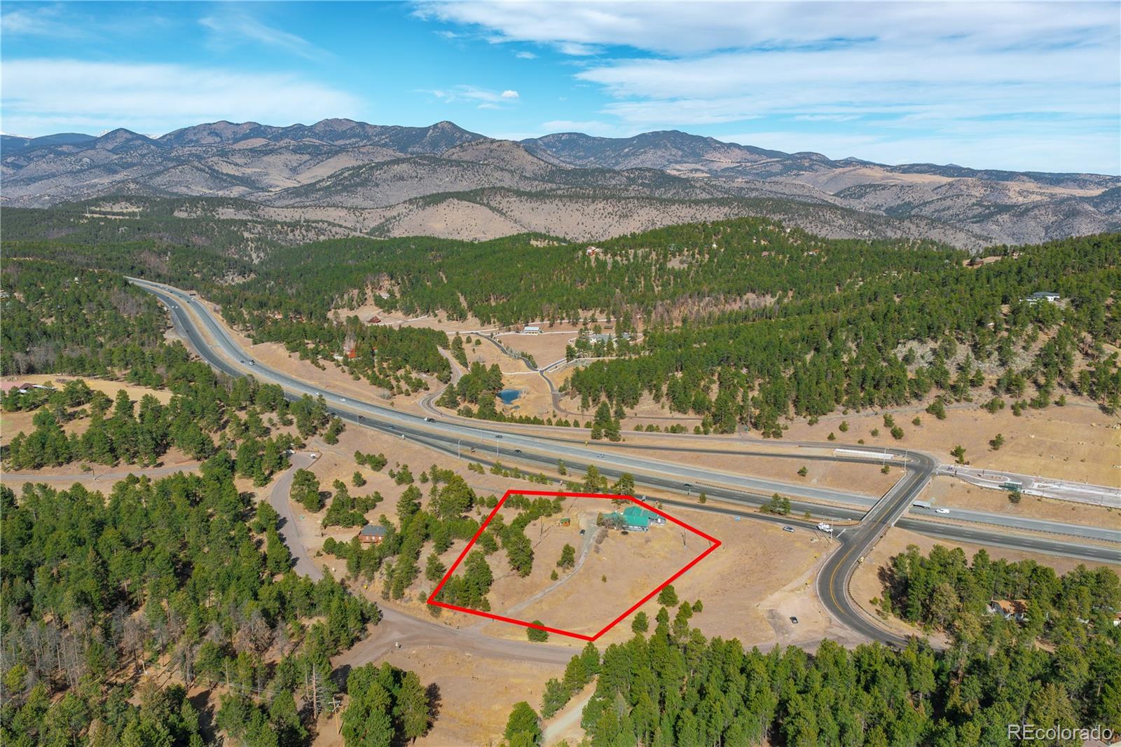 29793 Ruby Ranch Road Evergreen, CO 80439 - Photo 4 of 39 a view of a lush green hillside and a houses