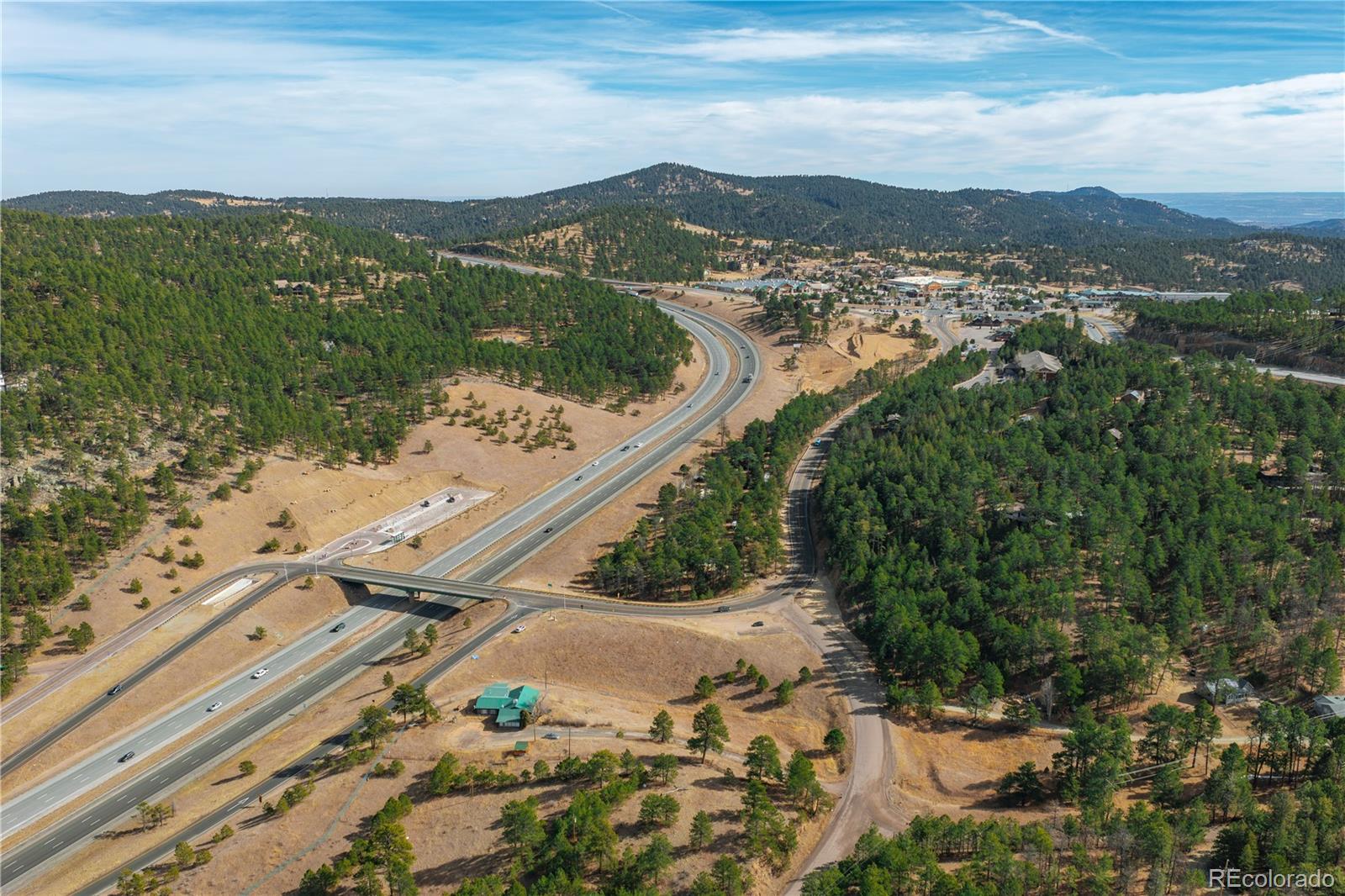 29793 Ruby Ranch Road Evergreen, CO 80439 - Photo 9 of 39 a view of a city with mountains in the background