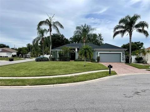 3901 Ballinore Place Gotha, FL 34734 - Photo 1 of 1 a view of a house with a swimming pool and a large tree with plants and big trees