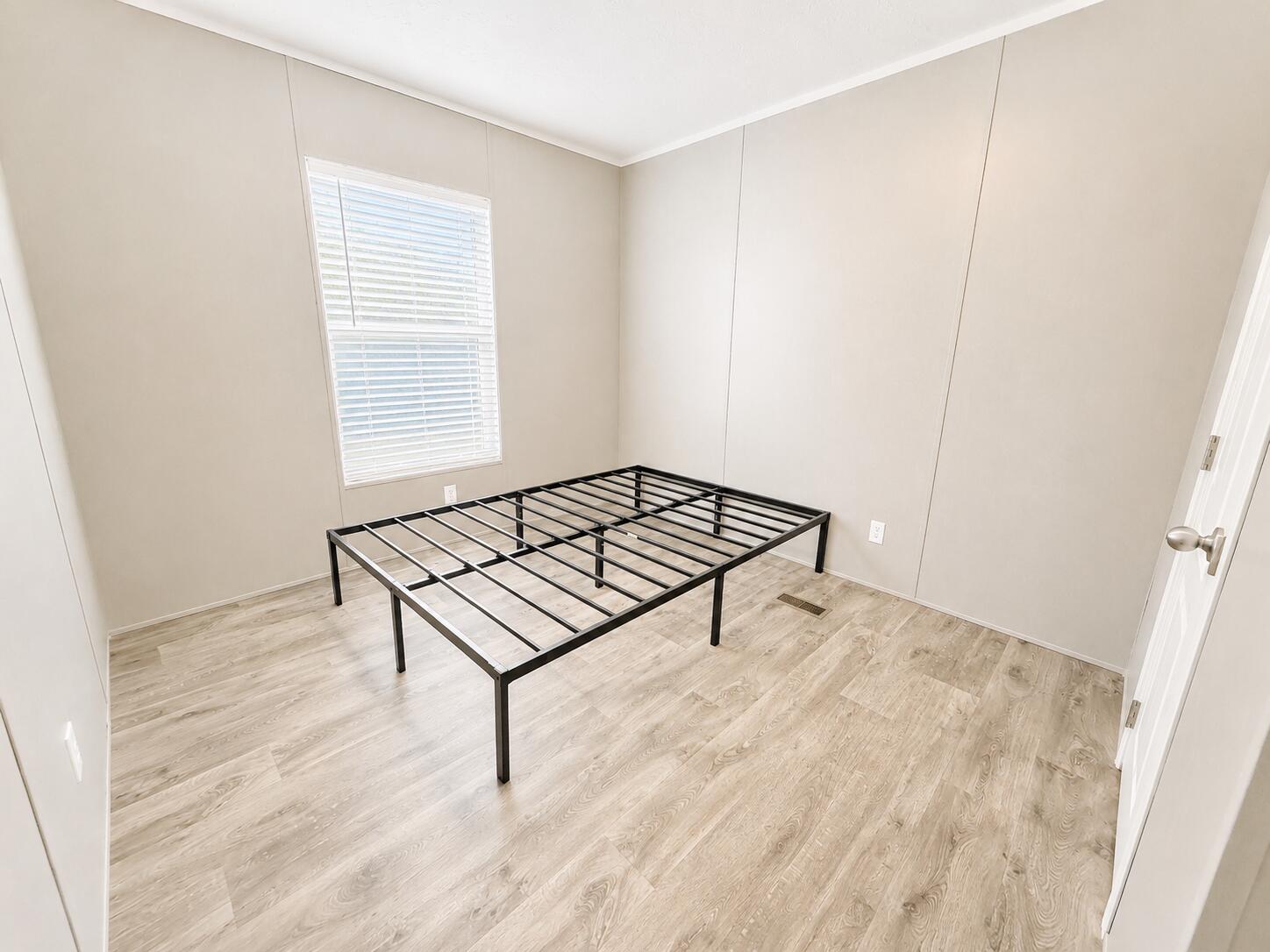 1121 Orange Loop Okeechobee, FL 34974 - Photo 18 of 33 Minimalist Bedroom with Black Bed Frame