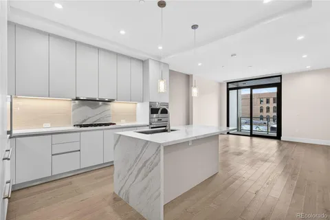 a kitchen with granite countertop a stove top oven sink and cabinets