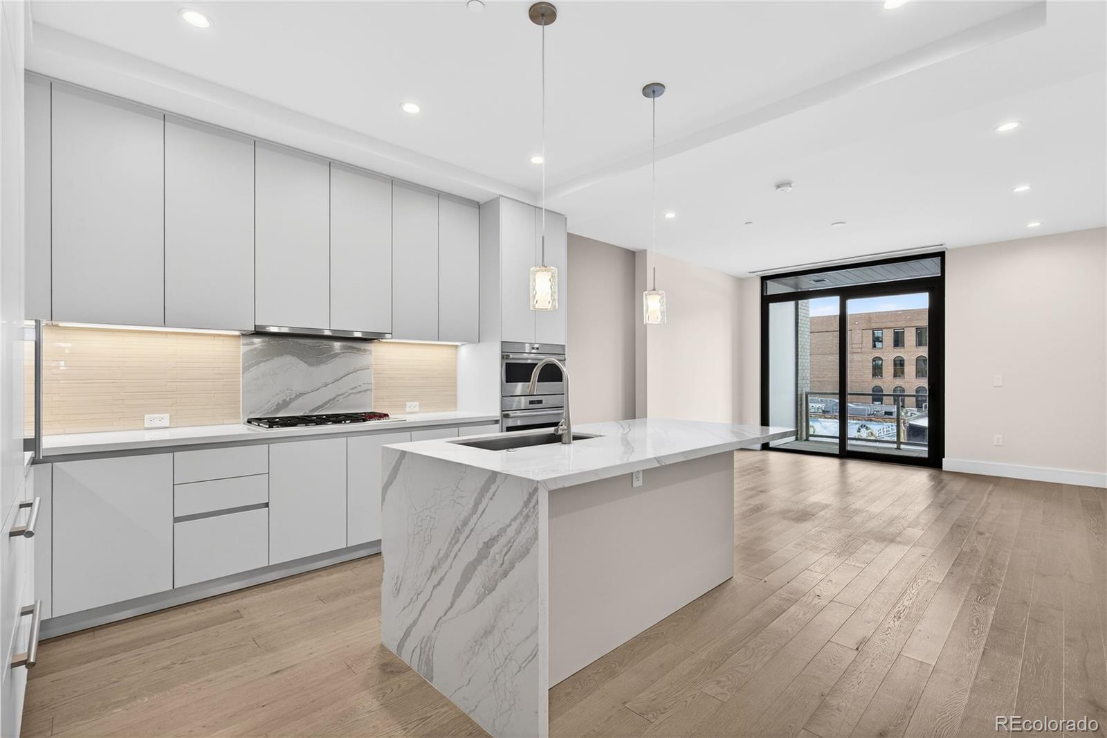 a kitchen with granite countertop a stove top oven sink and cabinets