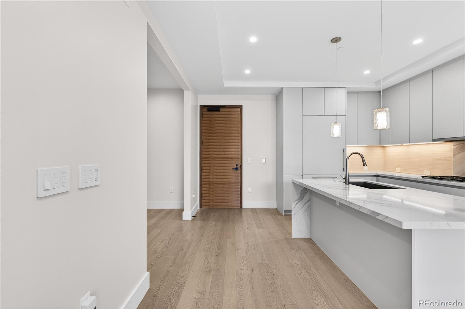 1901 Wazee Street, Unit 515 Denver, CO 80202 - Photo 11 of 46 a kitchen with granite countertop a sink and a stove top oven