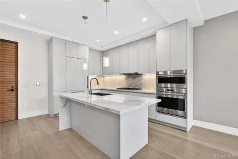 a kitchen that has a sink and a stove
