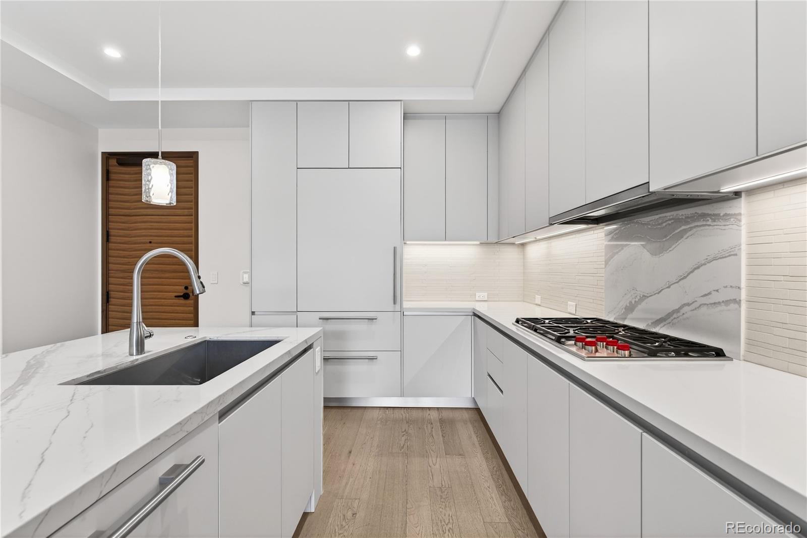 1901 Wazee Street, Unit 515 Denver, CO 80202 - Photo 13 of 46 a kitchen that has a sink and a stove