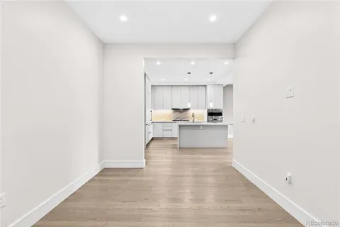 an empty room with cabinet and mirrors