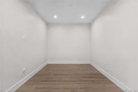 a view of a workspace with furniture and wooden floor