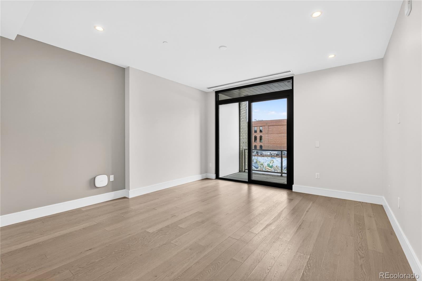 1901 Wazee Street, Unit 515 Denver, CO 80202 - Photo 18 of 46 a view of an empty room with wooden floor and a window