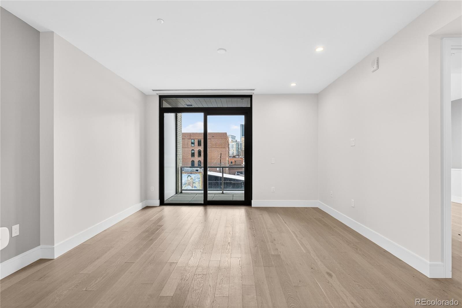 1901 Wazee Street, Unit 515 Denver, CO 80202 - Photo 20 of 46 wooden floor in an empty room with a window