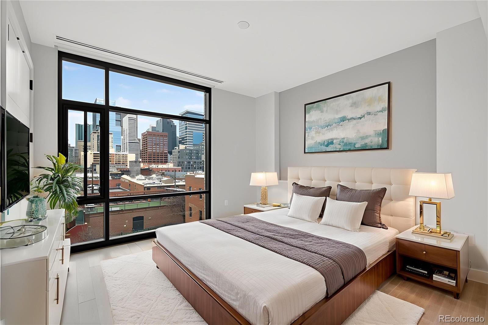 1901 Wazee Street, Unit 515 Denver, CO 80202 - Photo 2 of 46 a bedroom with a large bed and a chandelier