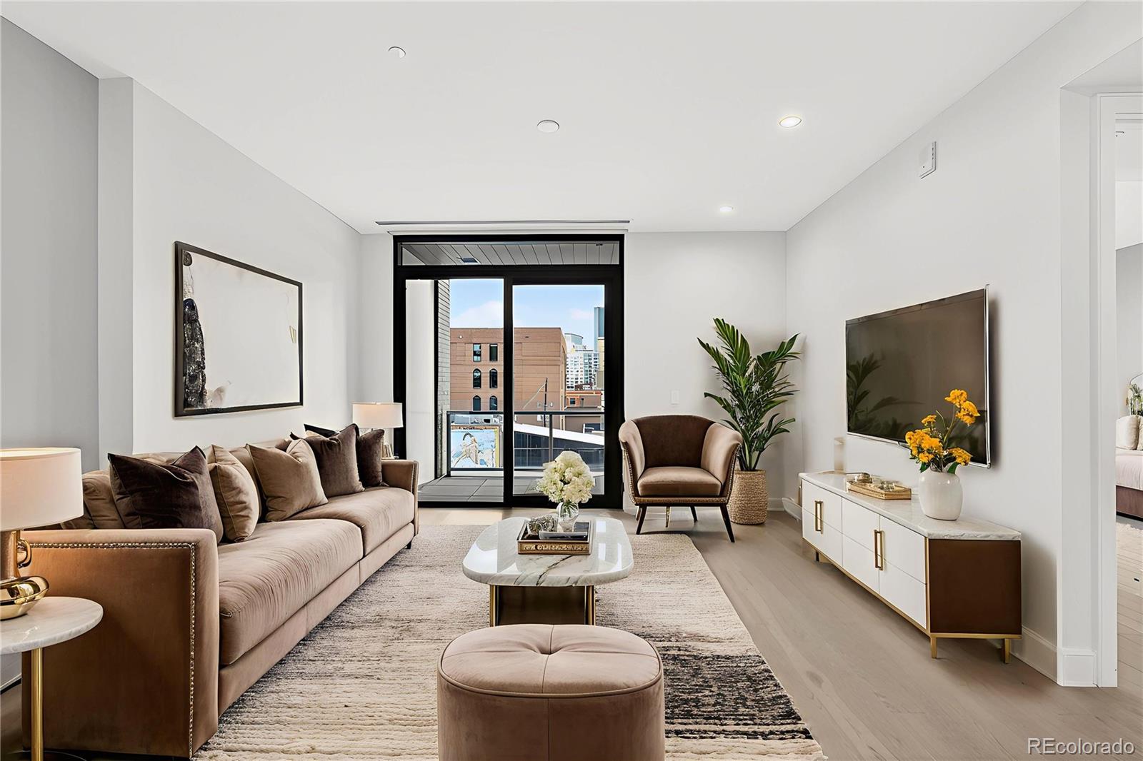 1901 Wazee Street, Unit 515 Denver, CO 80202 - Photo 2 of 46 a living room with furniture and a flat screen tv