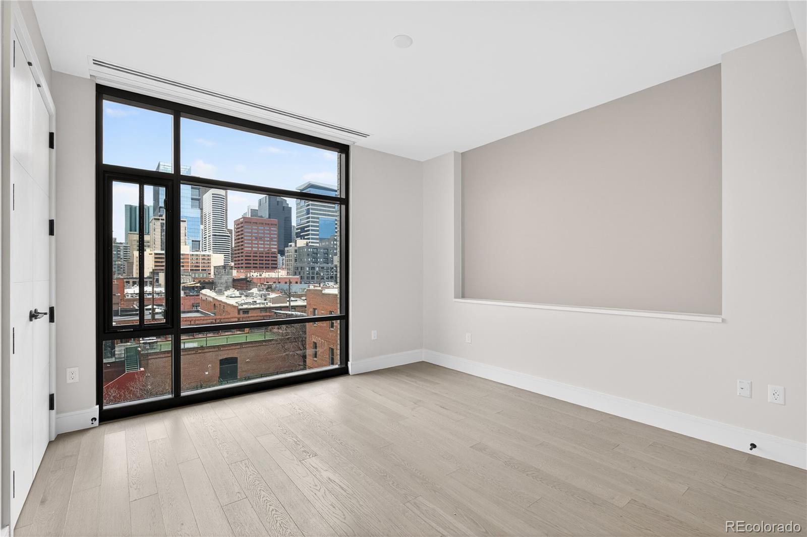 1901 Wazee Street, Unit 515 Denver, CO 80202 - Photo 31 of 46 a view of an empty room with wooden floor and a window