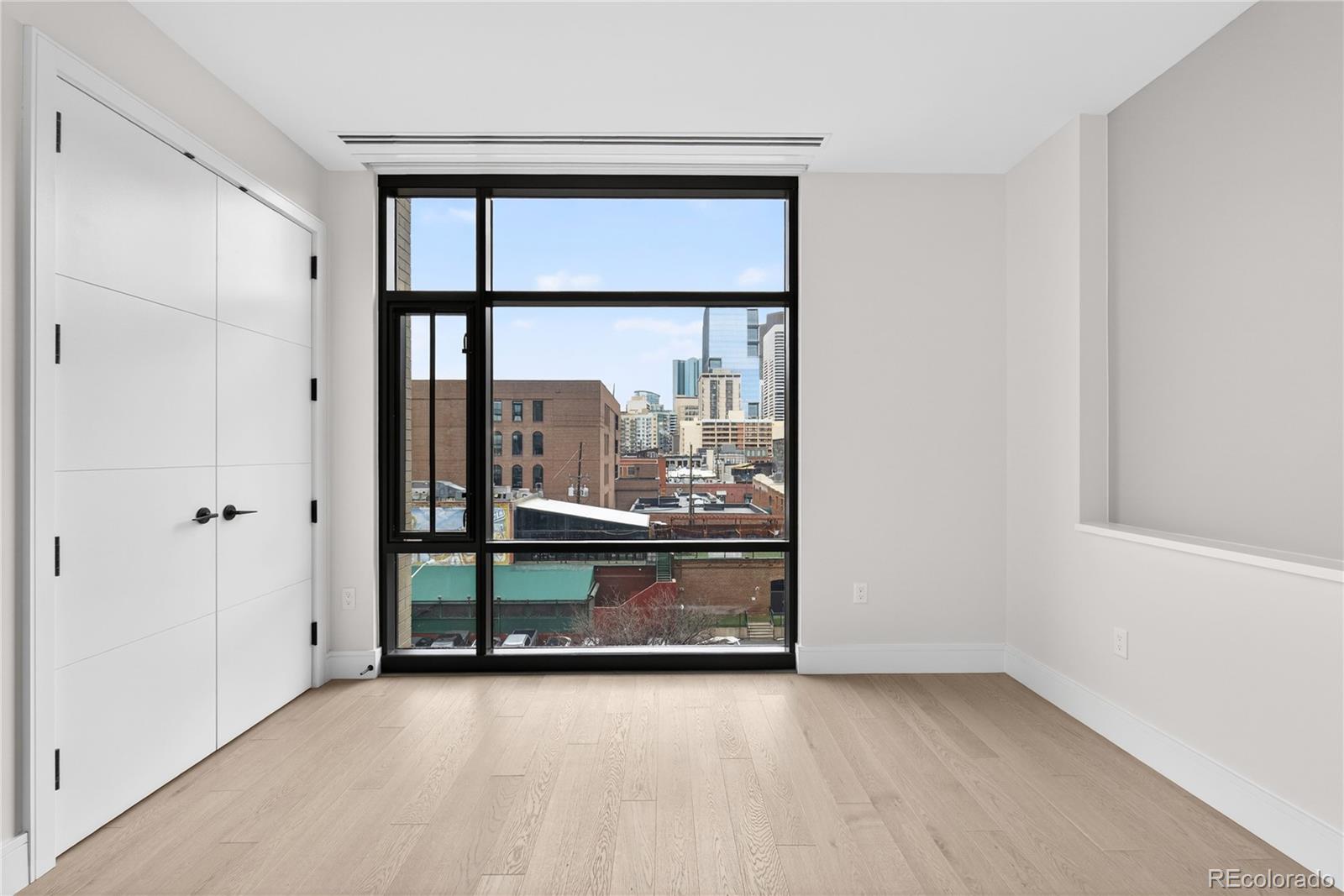 1901 Wazee Street, Unit 515 Denver, CO 80202 - Photo 32 of 46 an empty room with wooden floor and a window