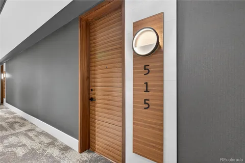 a kitchen with granite countertop white cabinets and stainless steel appliances