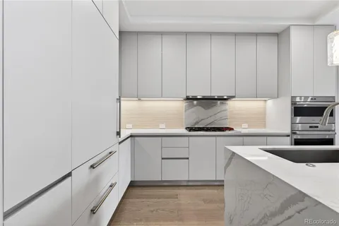 a kitchen with granite countertop a sink and a stove top oven