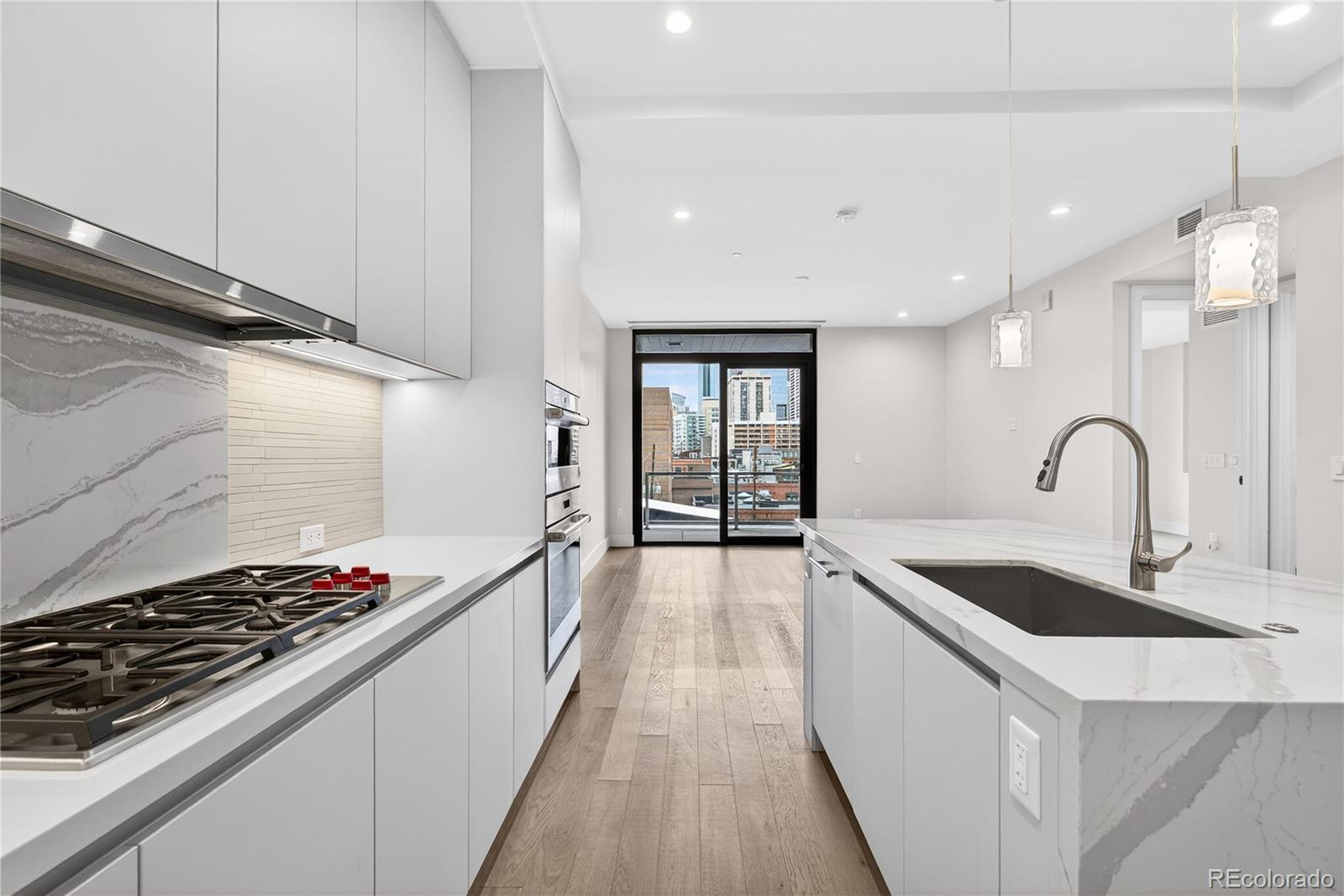 1901 Wazee Street, Unit 515 Denver, CO 80202 - Photo 8 of 46 a kitchen with sink stove and cabinets