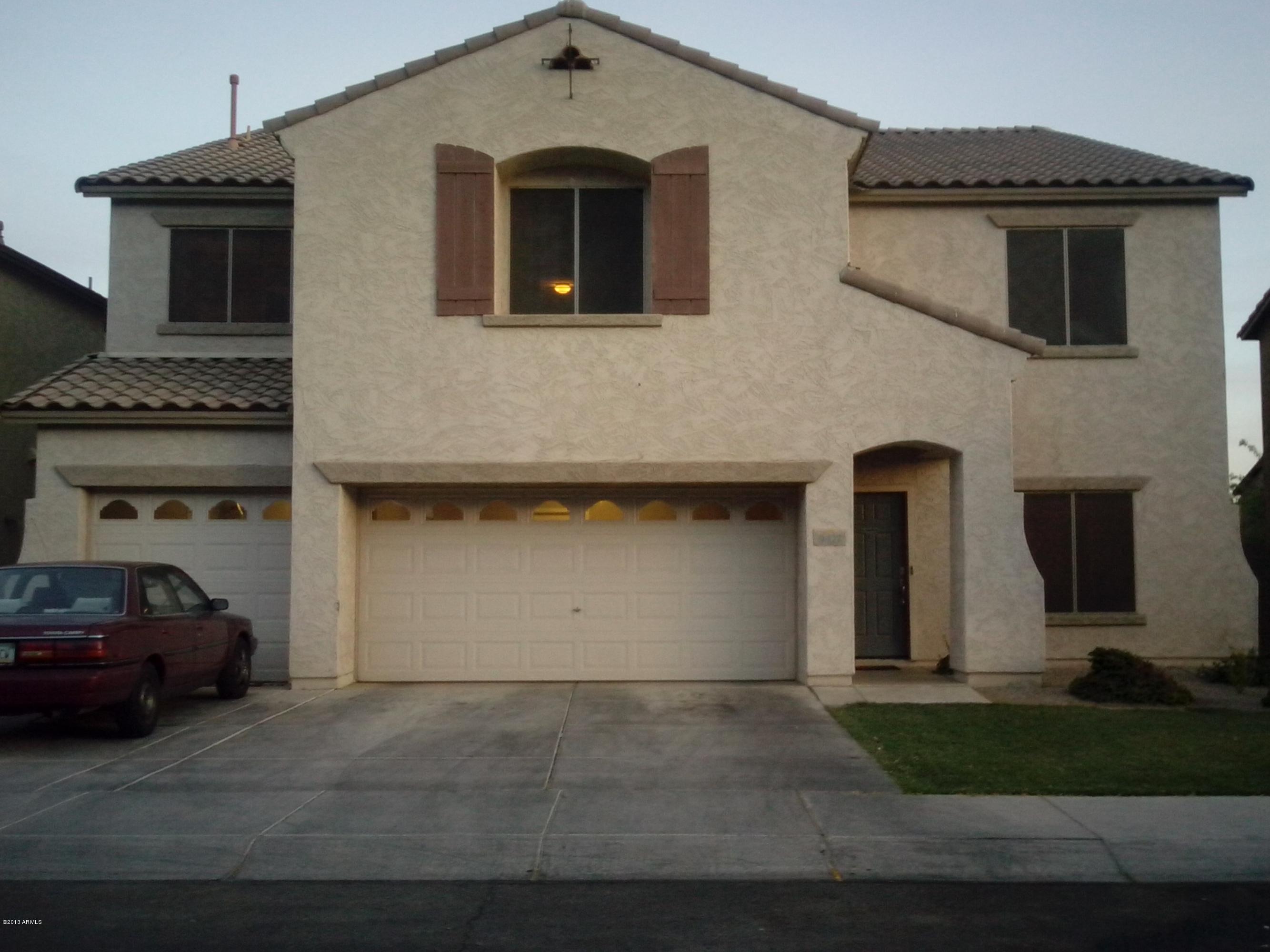 9427 West Monte Vista Road Phoenix, AZ 85037 - Photo 1 of 13 a front view of a house with a yard