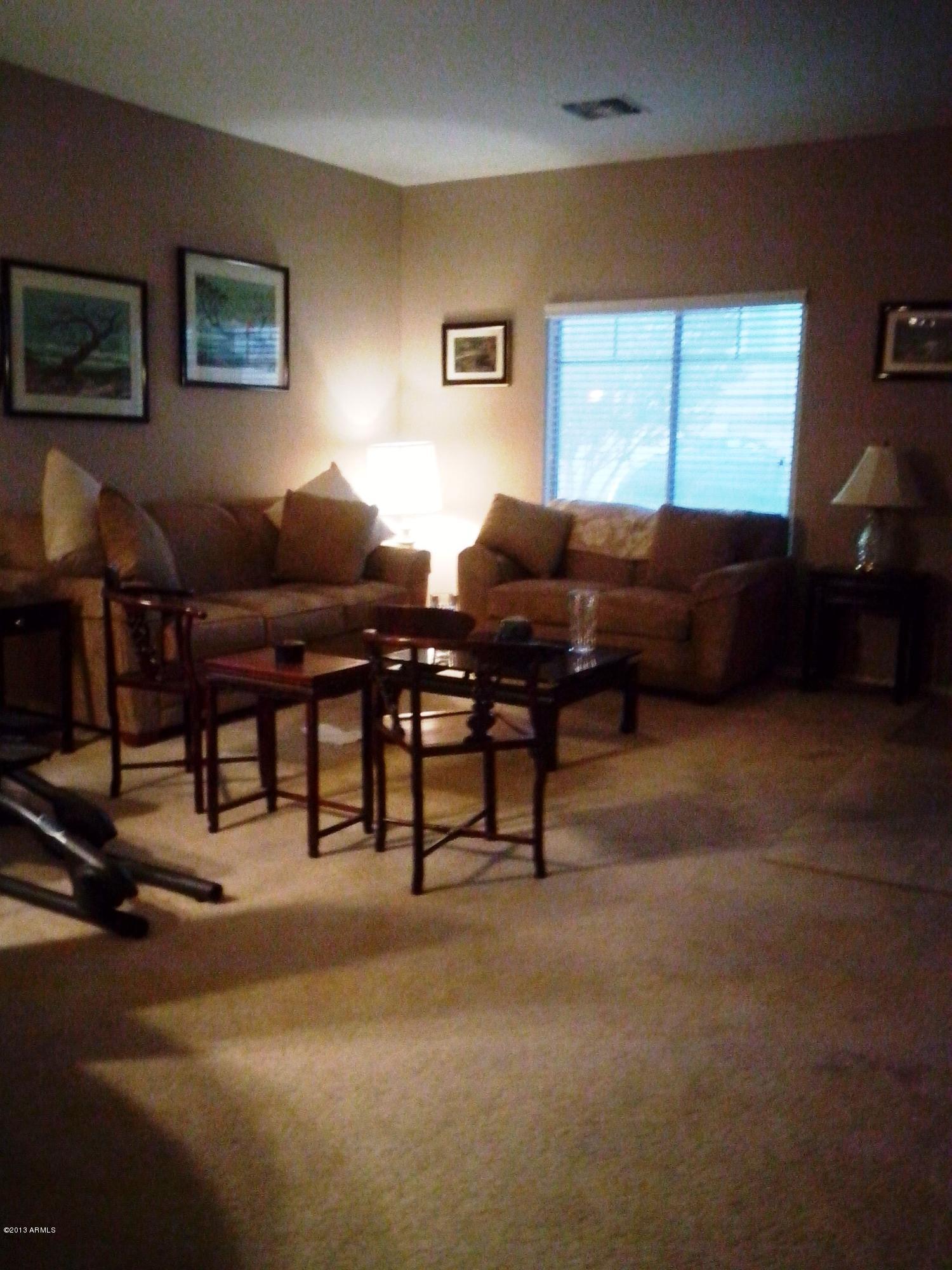 9427 West Monte Vista Road Phoenix, AZ 85037 - Photo 2 of 13 a living room with furniture and a window