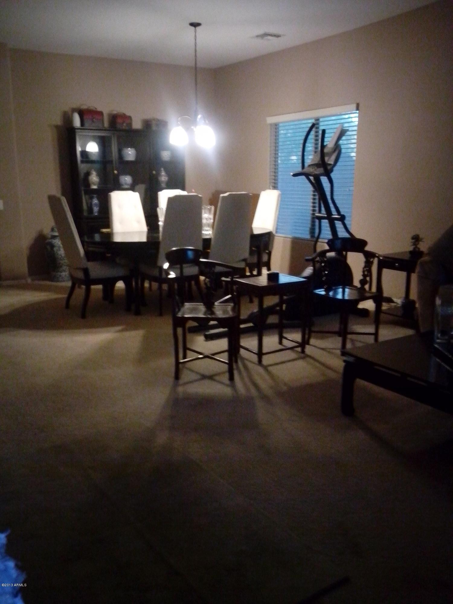 9427 West Monte Vista Road Phoenix, AZ 85037 - Photo 3 of 13 a room with lots of white furniture and a wooden floor