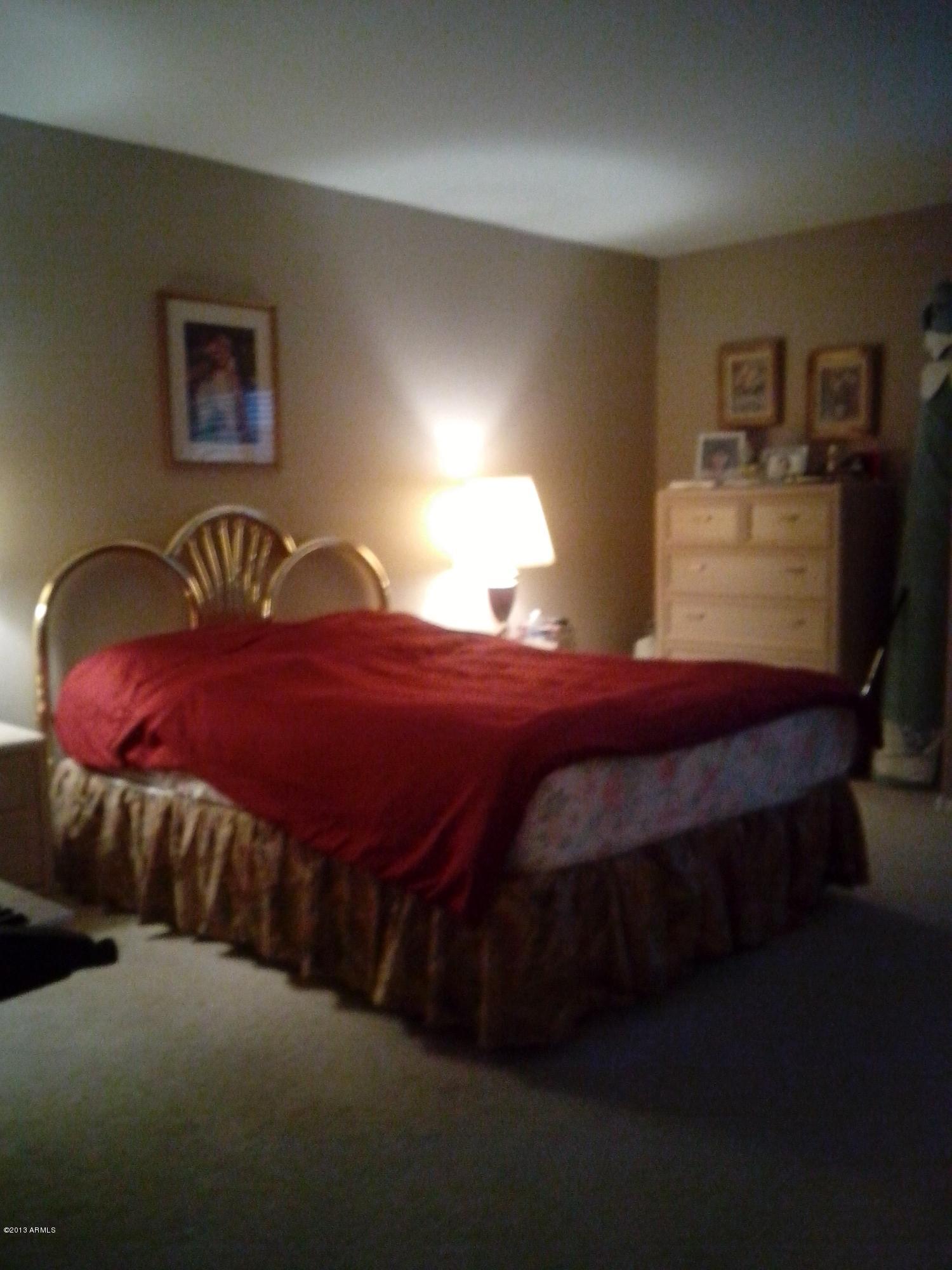 9427 West Monte Vista Road Phoenix, AZ 85037 - Photo 10 of 13 a bedroom with a bed dresser and window