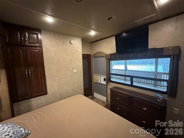 a bedroom with a bed and a television