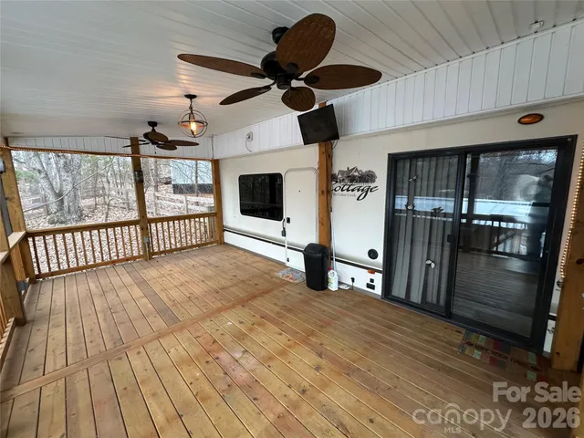 a view of a room with wooden floor and windows