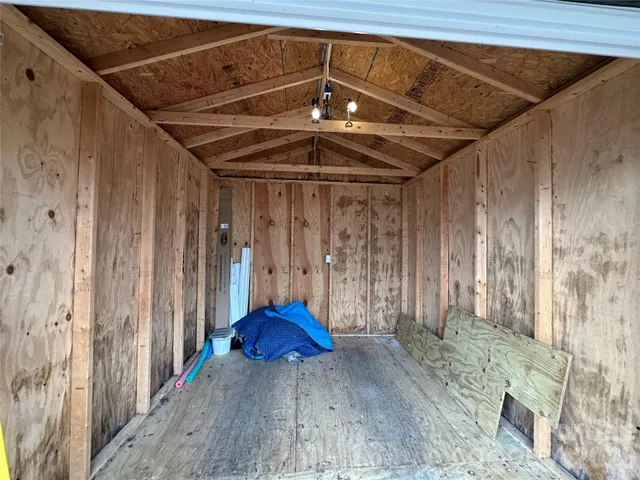 a view of a room with wooden walls