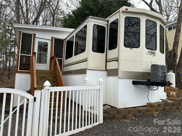 a view of a white house with iron fence