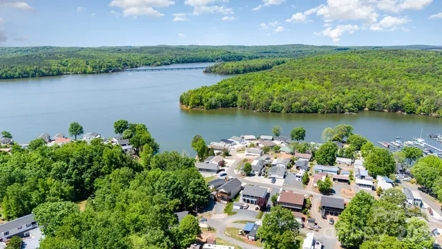 an aerial view of a house with a yard and lake view
