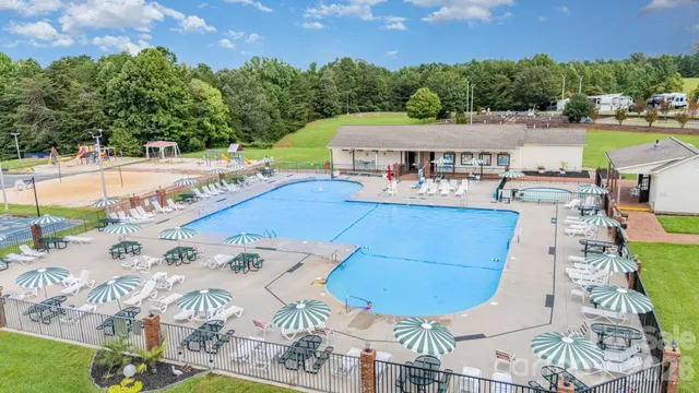 an aerial view of a house with swimming pool garden and patio